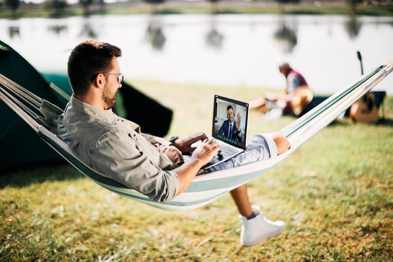 Hello colleague, do you enjoy camping? Remote Work Security in 3 Steps remote worker on laptop on zoom call