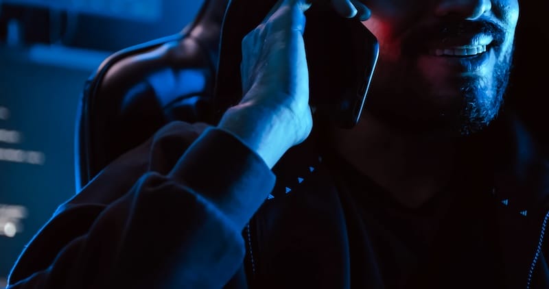 A male hacker is using a computer to hack data to demand ransom from victims.