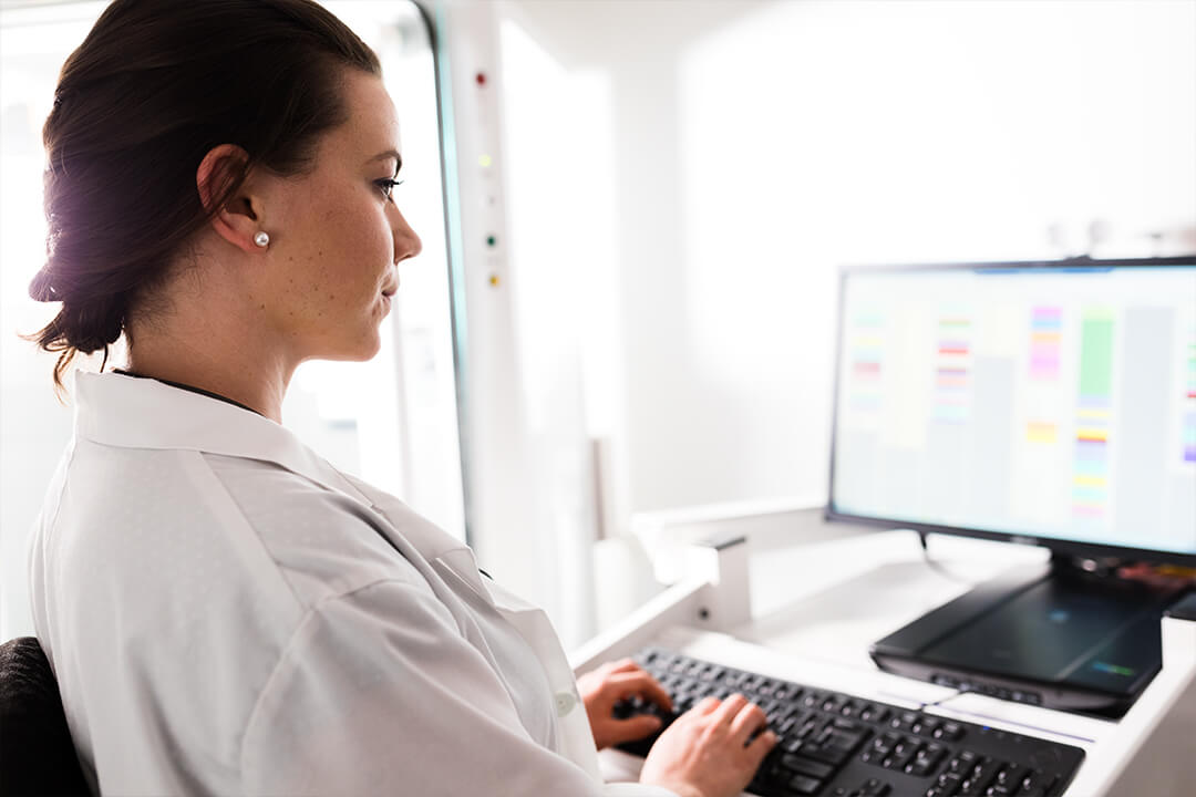 Female doctor working on a laptop at her office